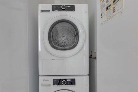 A white Whirlpool washing machine with a black control panel.