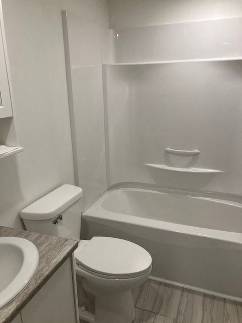 A white toilet sits next to a white bathtub in a bathroom.