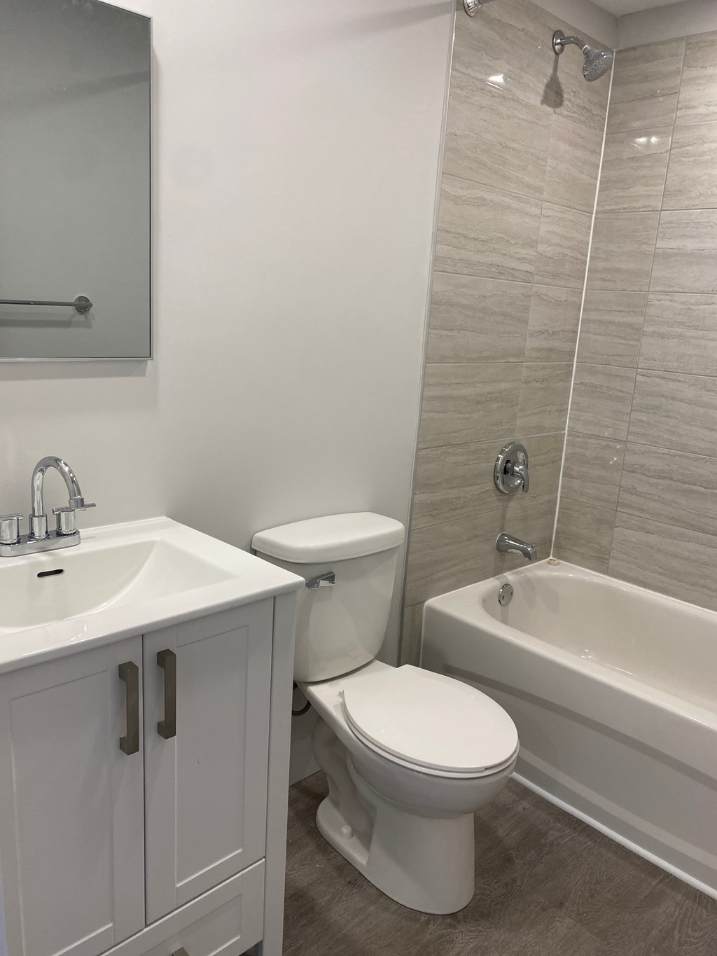 A white toilet sits next to a sink in a bathroom.