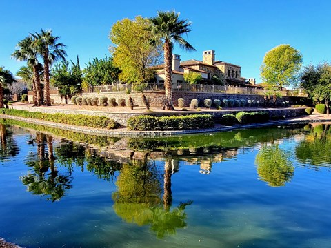 A building is reflected in the water in front of it.