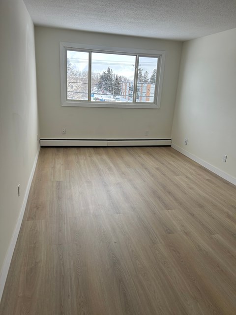 A room with a window showing a snowy landscape outside.