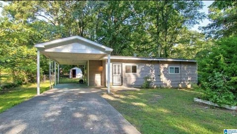 A house with a covered walkway leading to the front door.