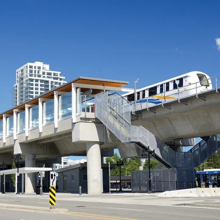 A train is passing over a concrete bridge.