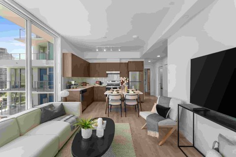 A modern living room with a large couch, a coffee table, and a television.