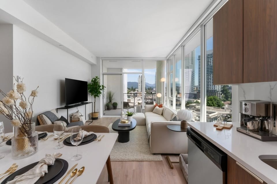 A modern kitchen and living room with a view of the city.