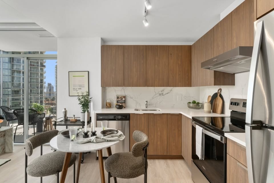 A modern kitchen with a dining table and chairs.