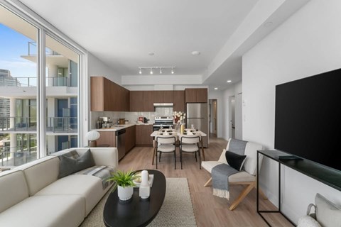 A modern living room with a black coffee table and a white sofa.
