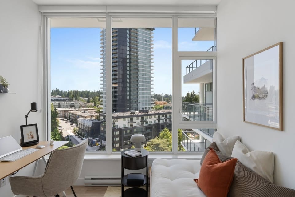 A modern living room with a view of a cityscape through a large window.