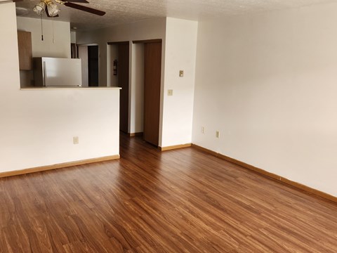 A room with wooden floors and white walls.