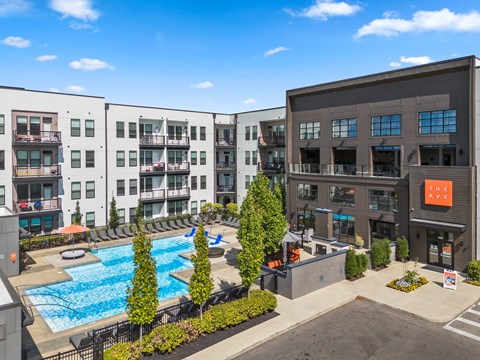 A large building with a pool in front of it.