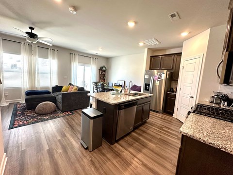 A modern kitchen with a large island and stainless steel appliances.