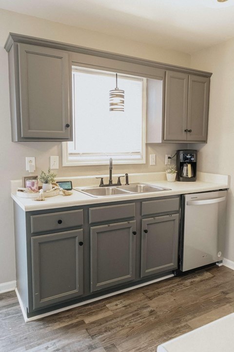 A kitchen with a sink and a window.