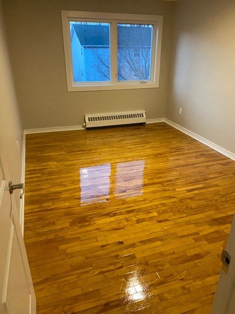 A room with wooden floors and a window.