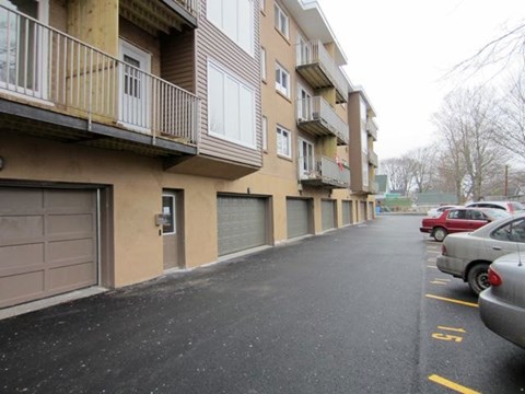 A parking lot in front of apartment buildings.