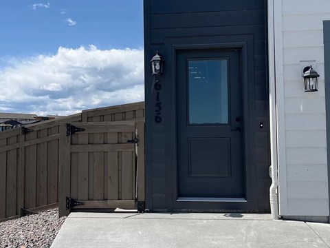 A grey door with the number 6153 on it.