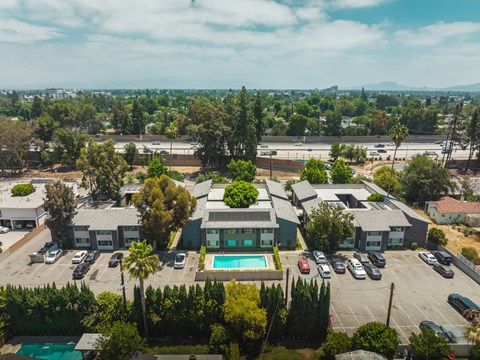 A large building with a pool in the middle of a parking lot.