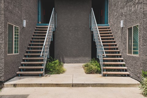 A house with a staircase leading to the front door.
