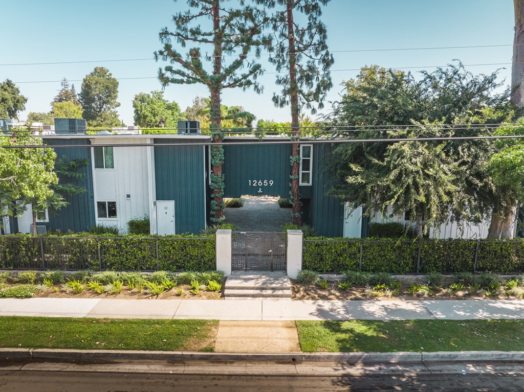 A green building with the number 1245 on it.