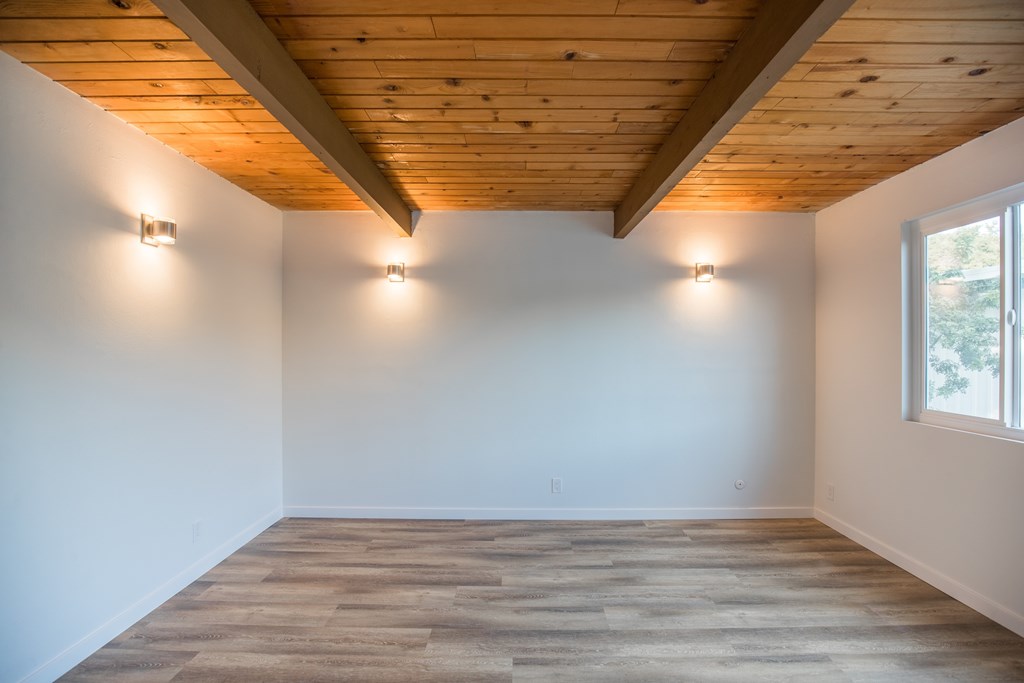 A room with wooden ceiling and floor.