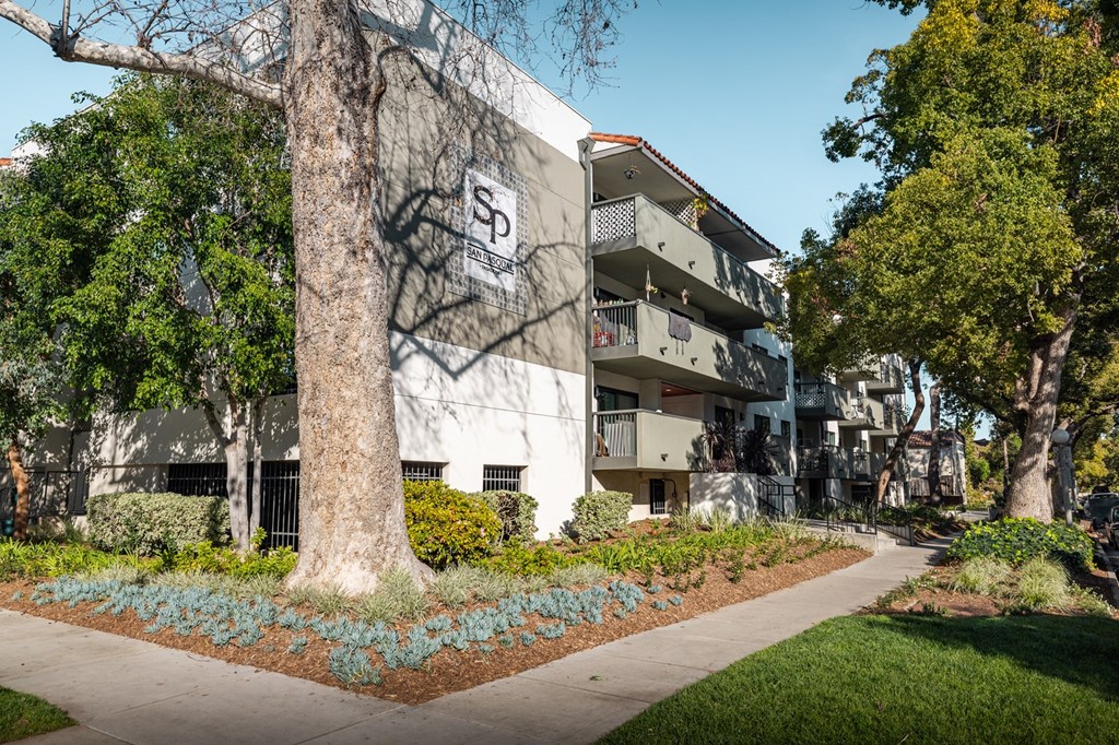 A building with a large tree in front of it.