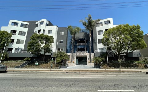 A modern building with a glass entrance and a sign that reads "MONARCH".