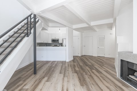 A modern living room with a staircase leading to the upper floor.