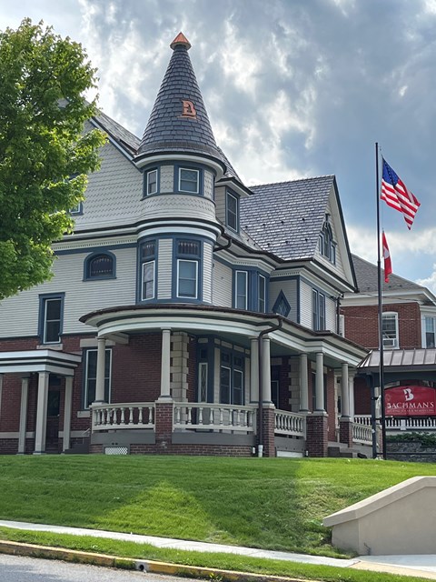 A large house with a flag on the front.