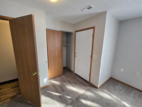 A room with a brown door and a white door.