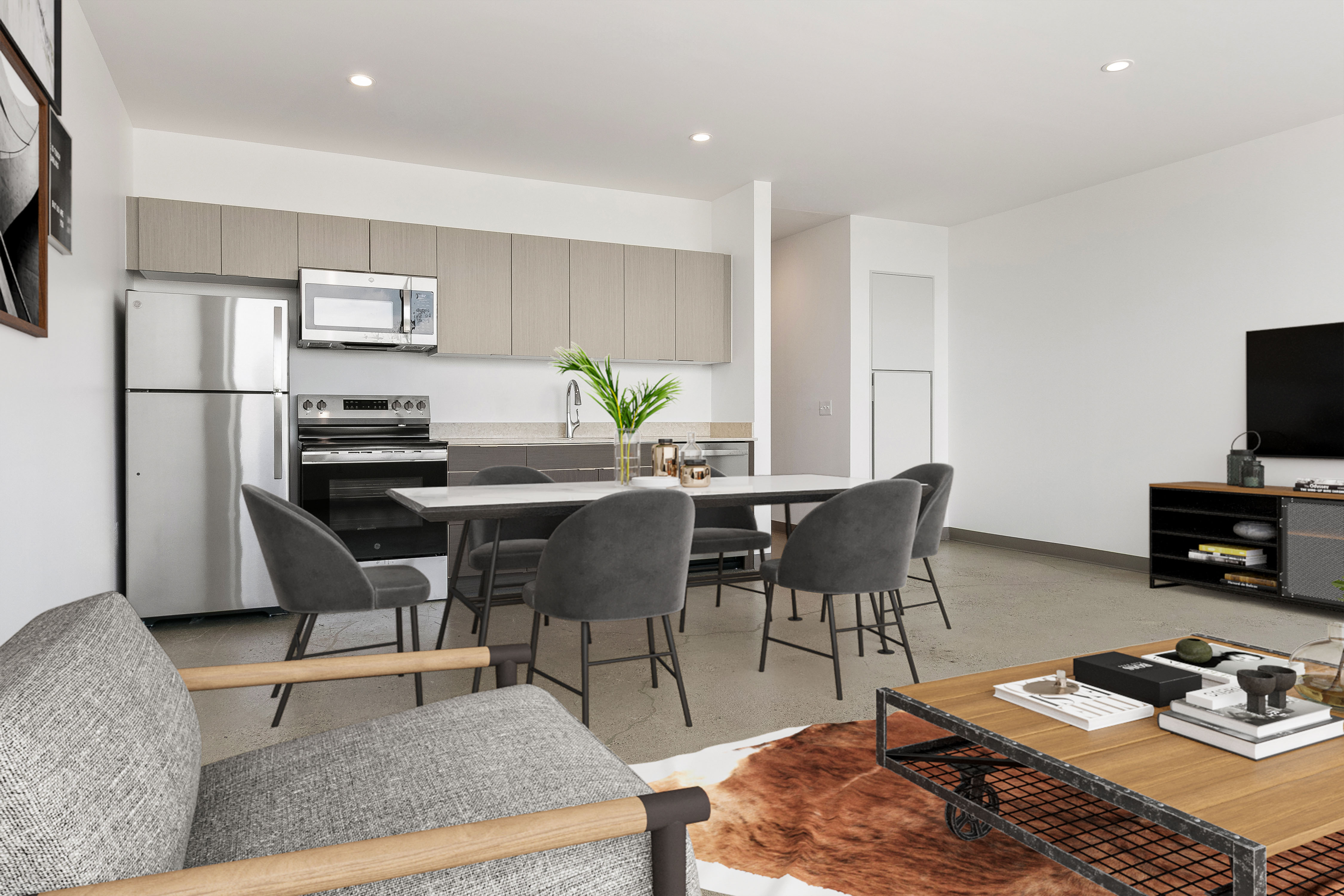 A modern kitchen with a dining table and grey chairs.