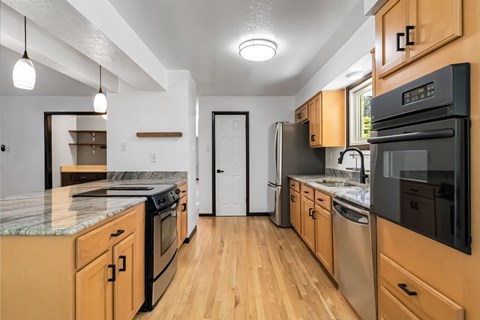 A kitchen with wooden cabinets and stainless steel appliances.
