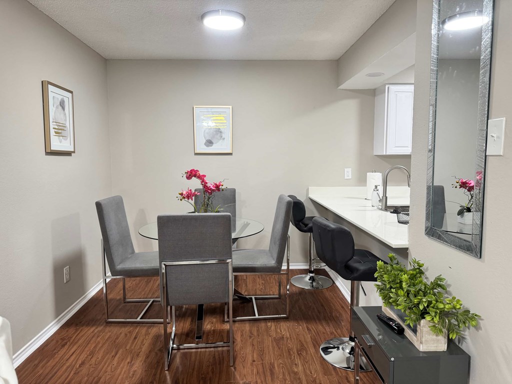A dining room with a table and chairs.