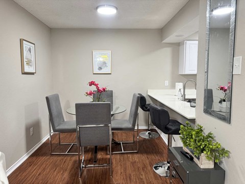 A dining room with a table and chairs.