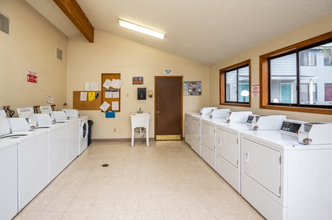 A laundromat with rows of washers and dryers.