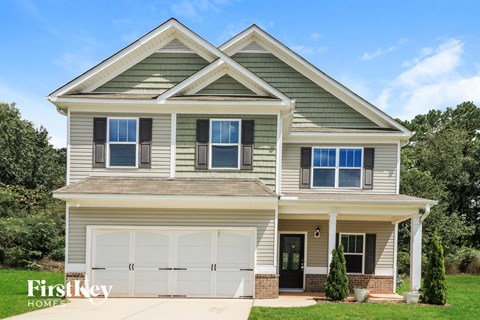A two-story house with a garage is for sale.