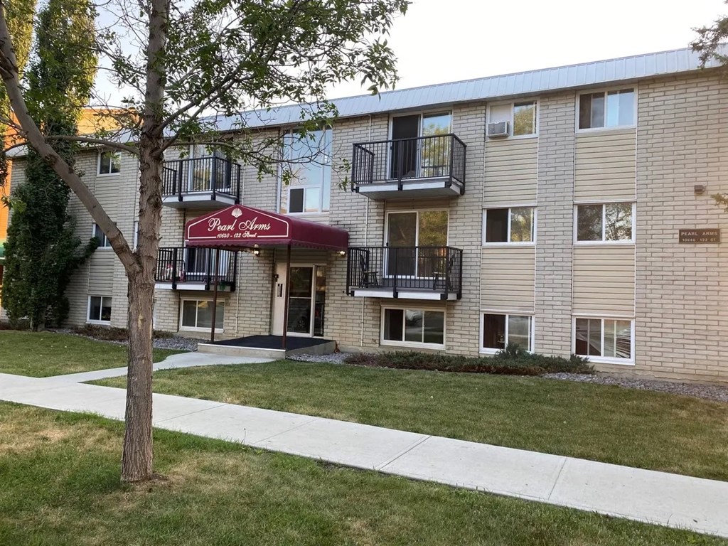 A building with a red awning and balconies.