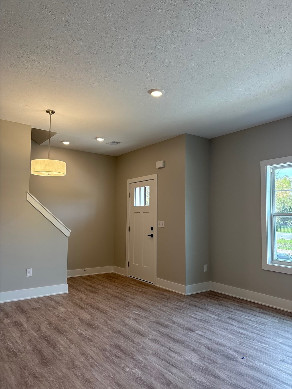 A room with a staircase and a door.