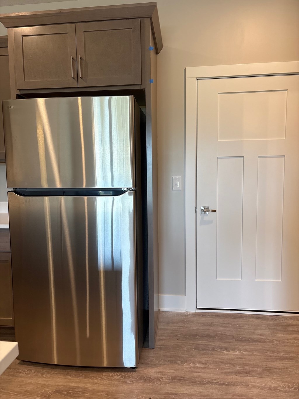 A stainless steel refrigerator in a kitchen.