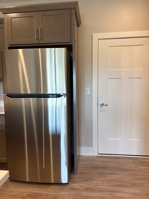 A stainless steel refrigerator in a kitchen.