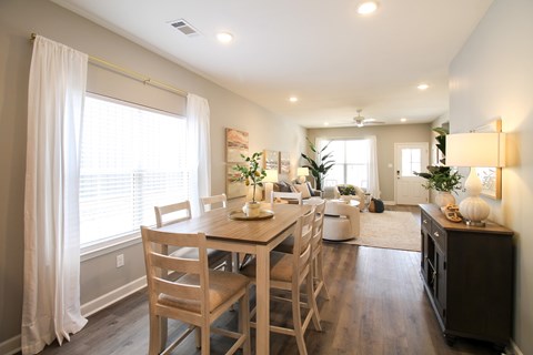 A dining room with a table and chairs.