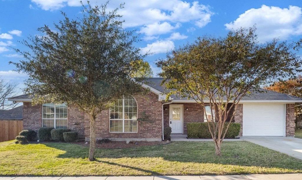 A house with a tree in front of it.