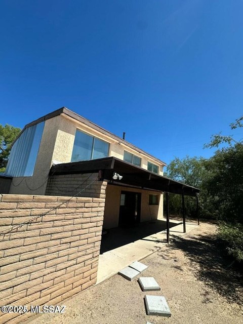A house with a clear blue sky above it.