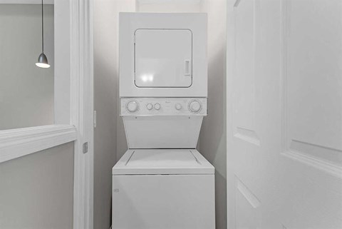 A white microwave oven is built into a cabinet.