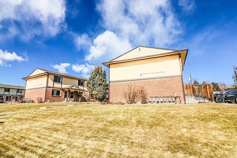 A large building with a grassy field in front of it.