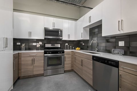 A modern kitchen with a stainless steel dishwasher and oven.