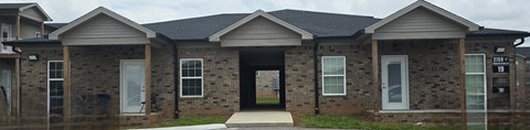 A house with a grey roof and a black door.