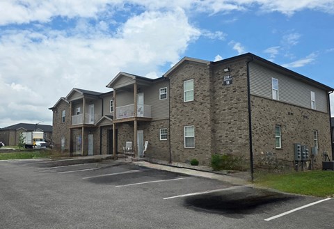 A large building with a parking lot in front of it.