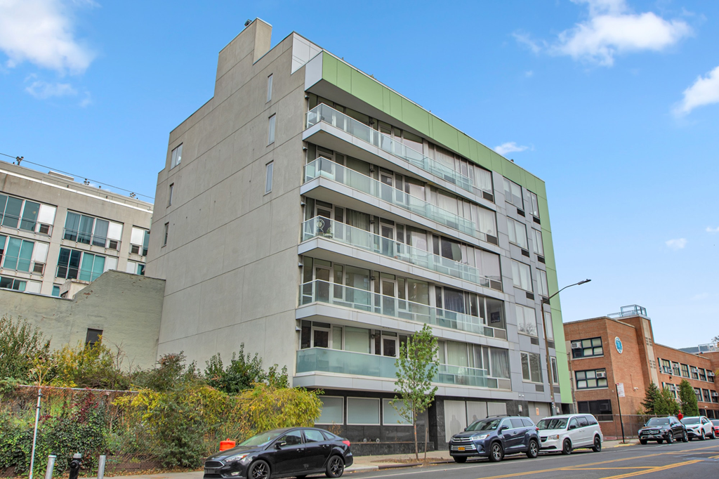 A modern building with a green accent on the side.