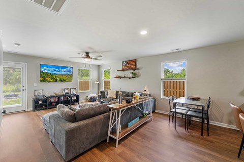 A living room with a grey couch and a wooden table.