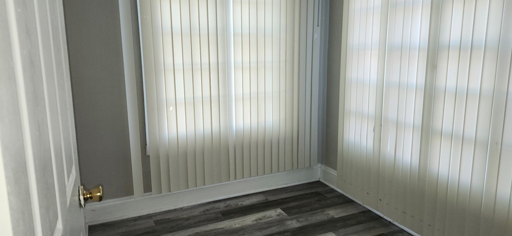 A white door with a gold handle is closed.