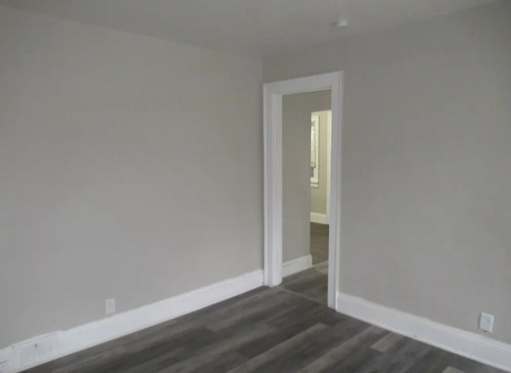 A room with a doorway leading to another room.